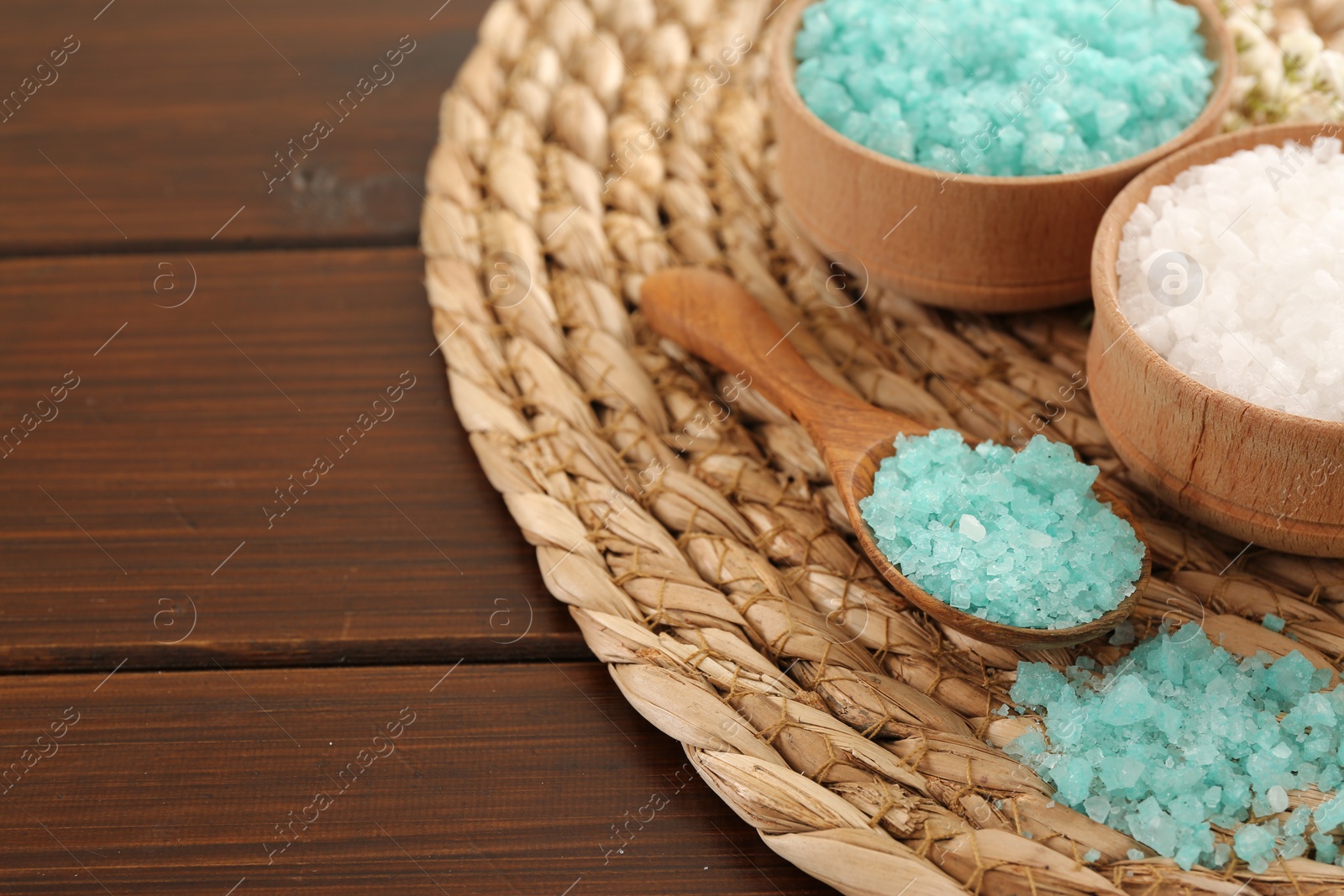 Photo of Aromatic sea salt on wooden table. Space for text