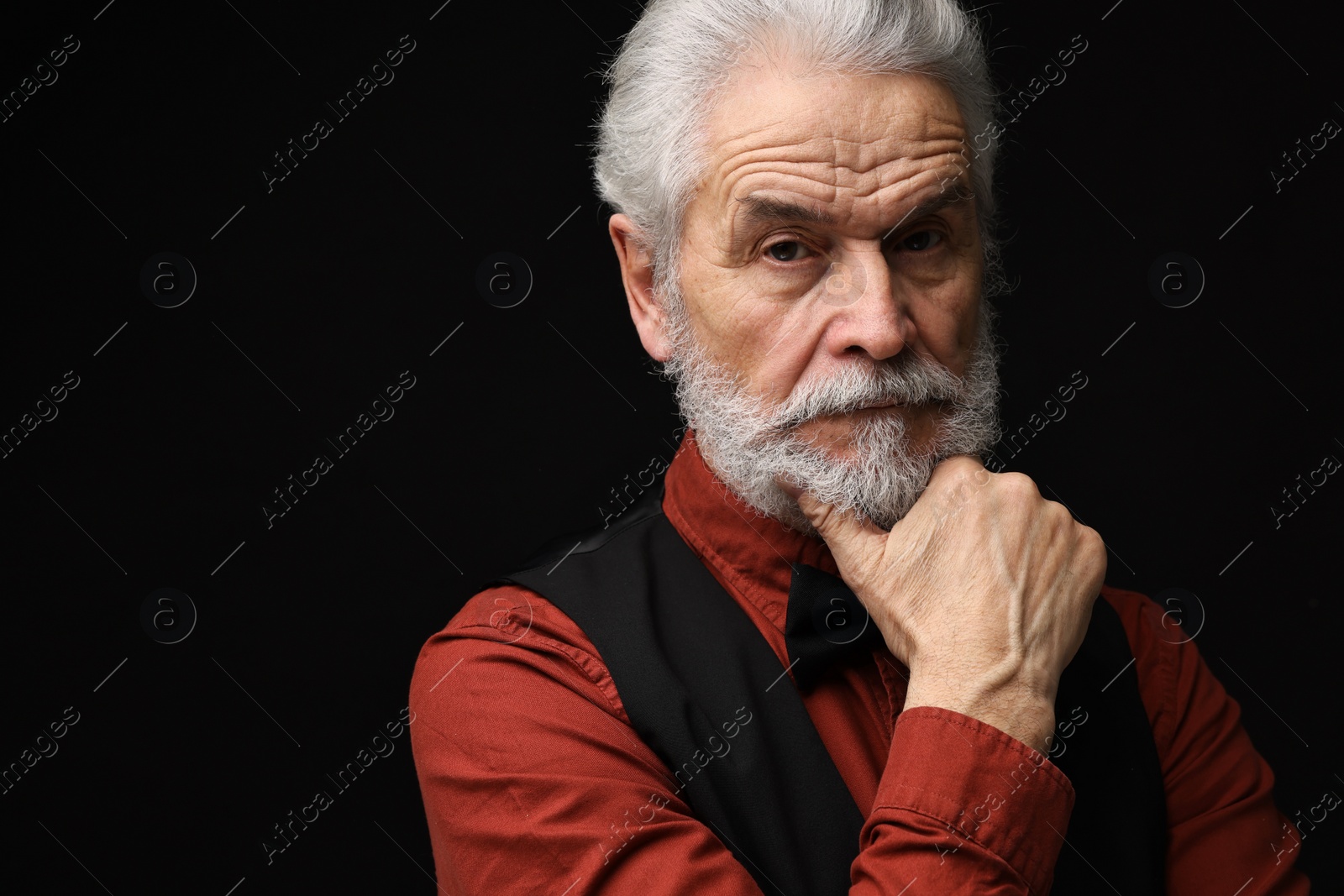 Photo of Senior man with mustache on black background, space for text