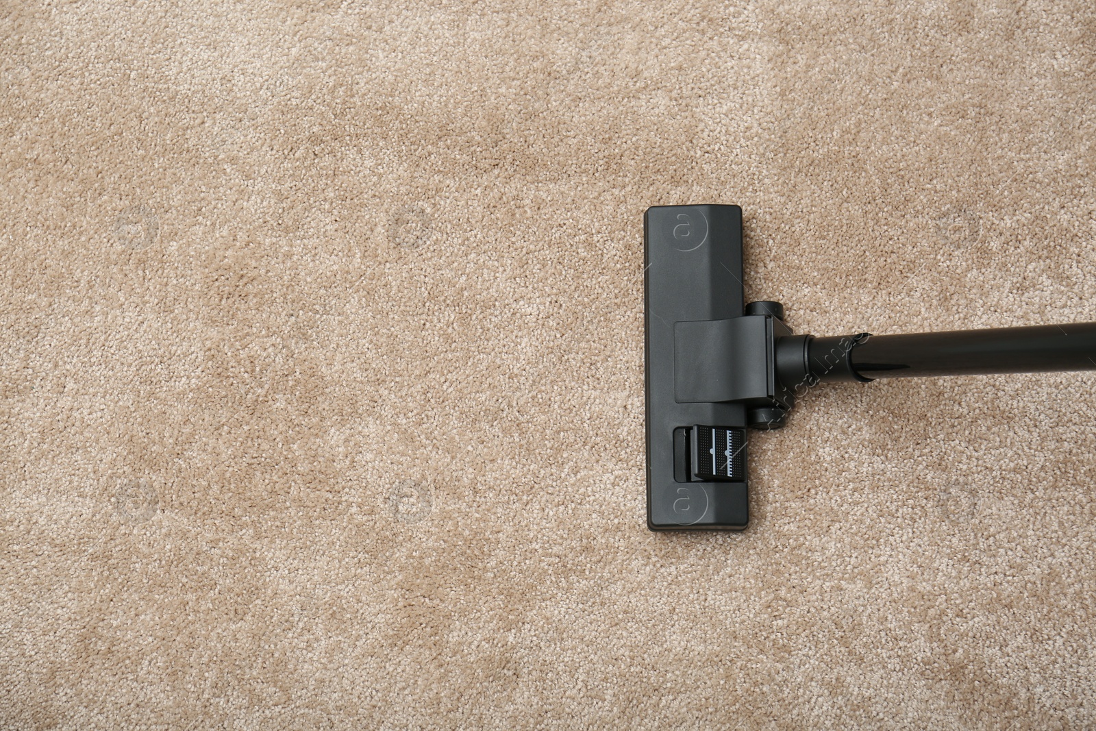 Photo of Removing dirt from carpet with vacuum cleaner indoors, top view. Space for text