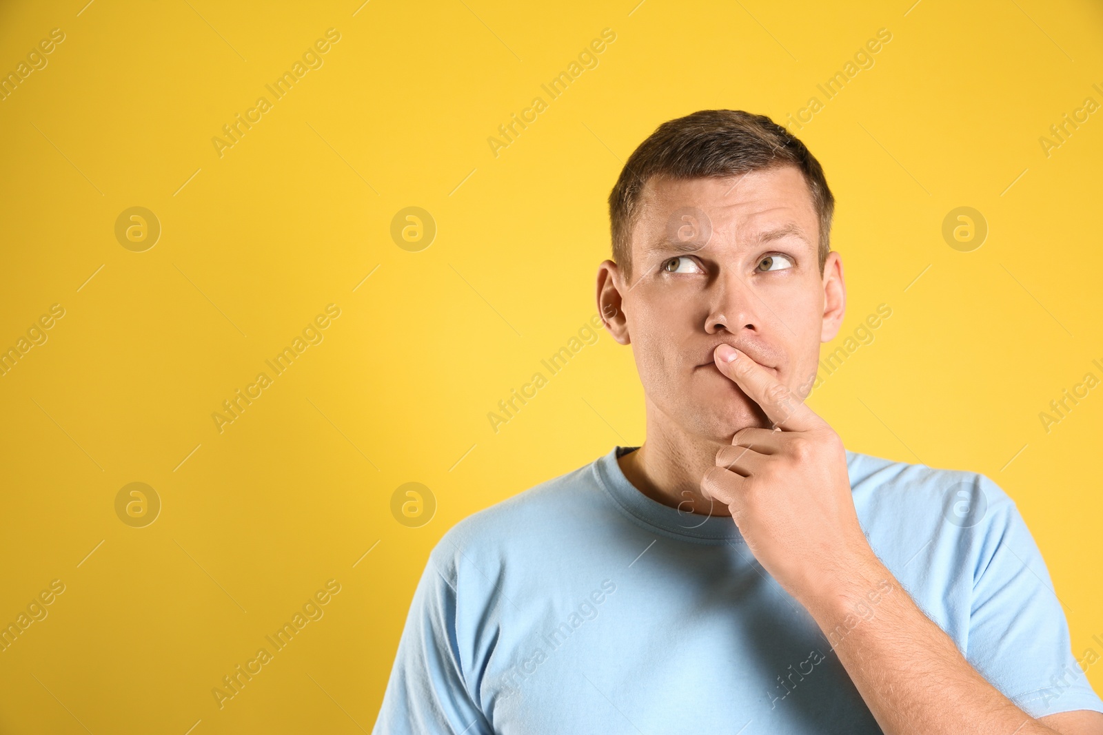 Photo of Thoughtful man on yellow background, space for text