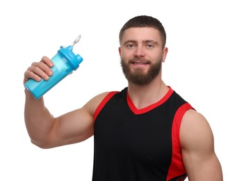 Young man with muscular body holding shaker of protein on white background