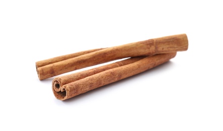 Photo of Aromatic cinnamon sticks on white background