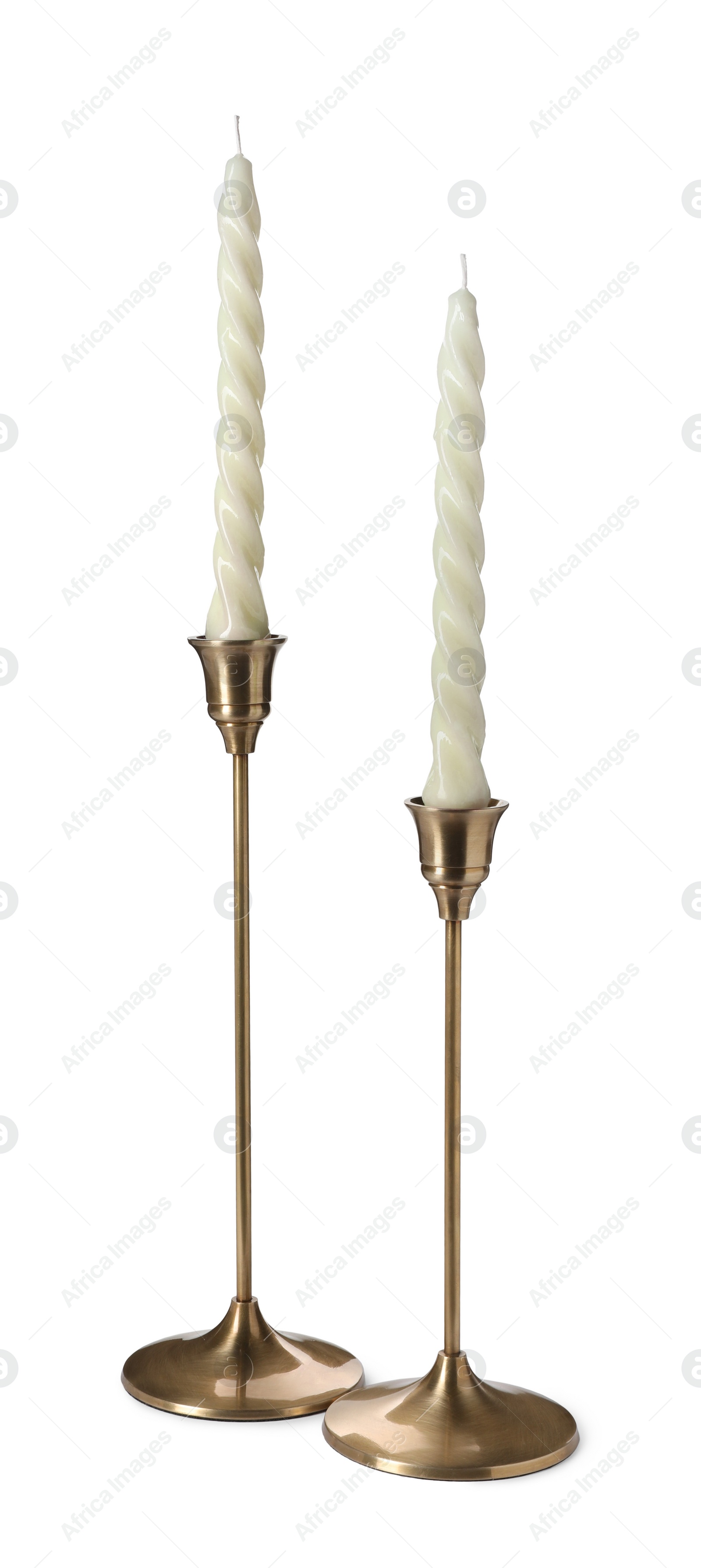 Photo of Vintage metal candlesticks with candles on white background