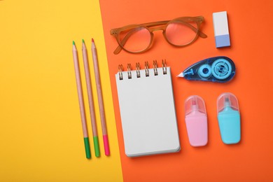 Photo of Flat lay composition with different school stationery and glasses on color background, space for text. Back to school
