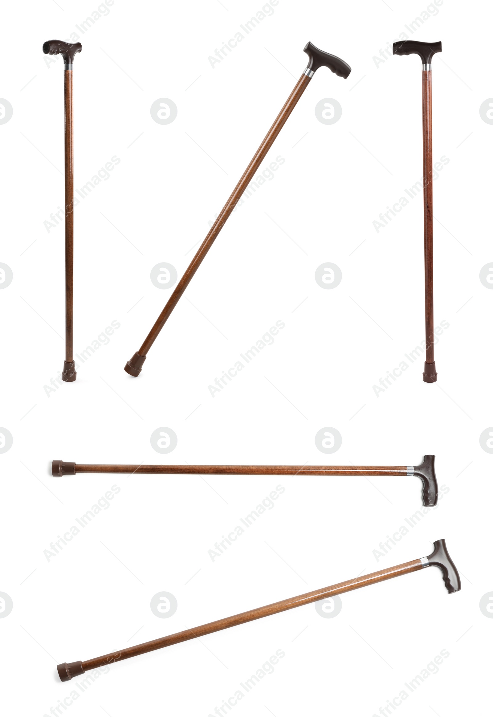 Image of Set with elegant wooden walking canes on white background