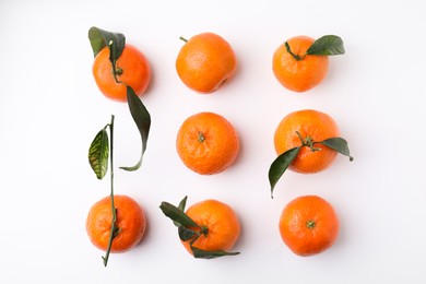 Fresh ripe tangerines with leaves on white background, flat lay