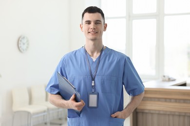 Photo of Portrait of smiling medical assistant with clipboard in hospital