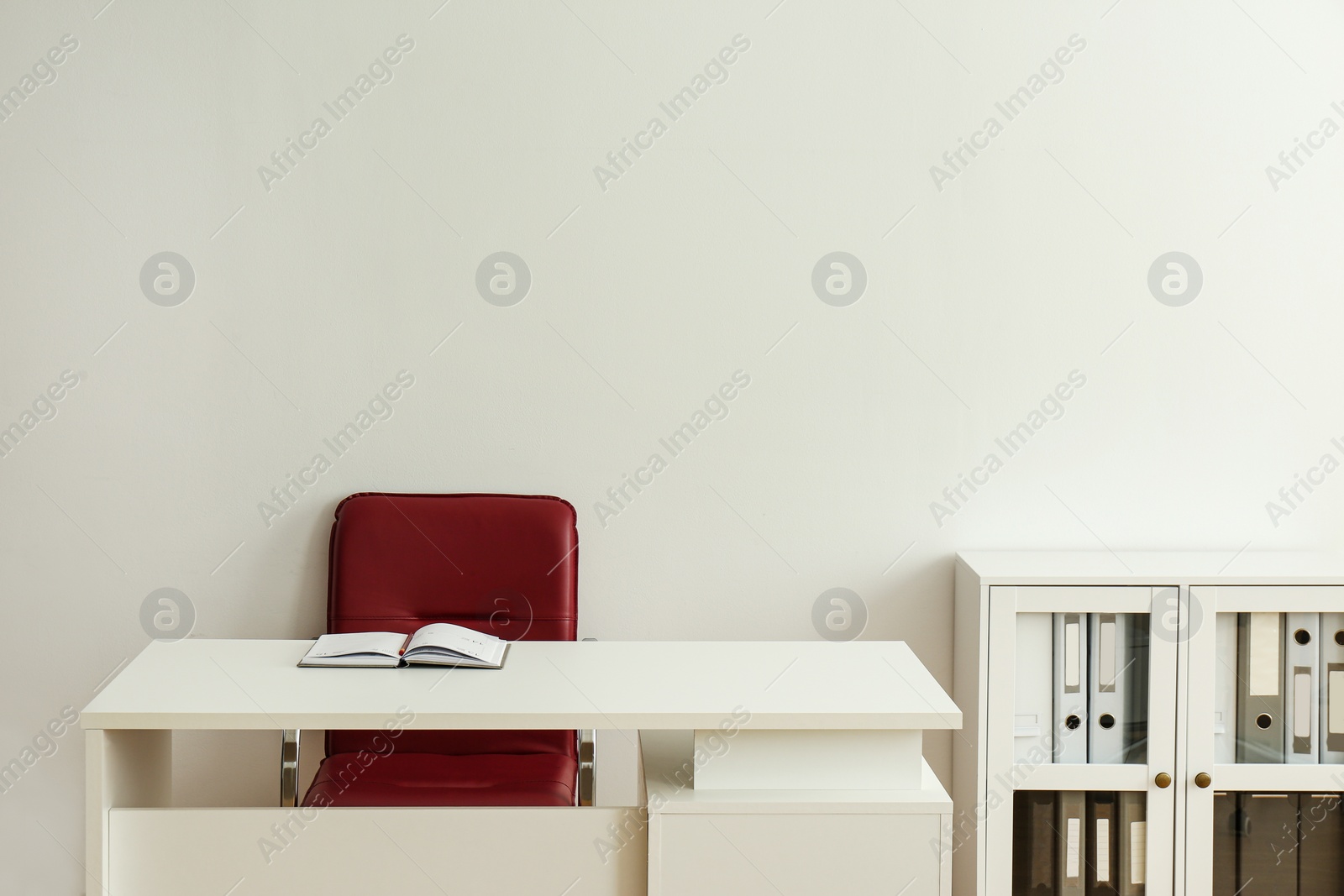 Photo of Stylish workplace interior with modern office chair and desk