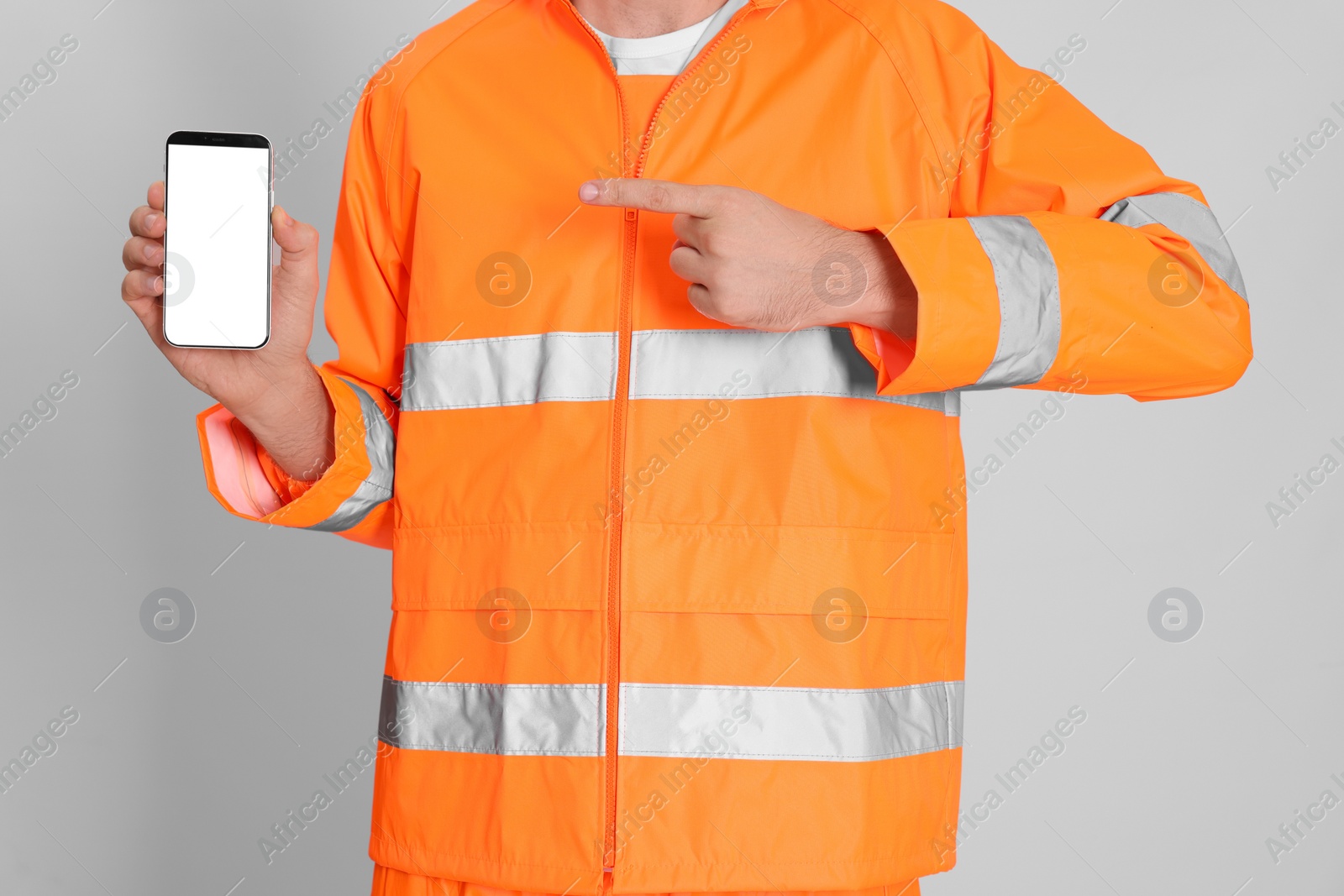 Photo of Man in reflective uniform with phone on white background, closeup