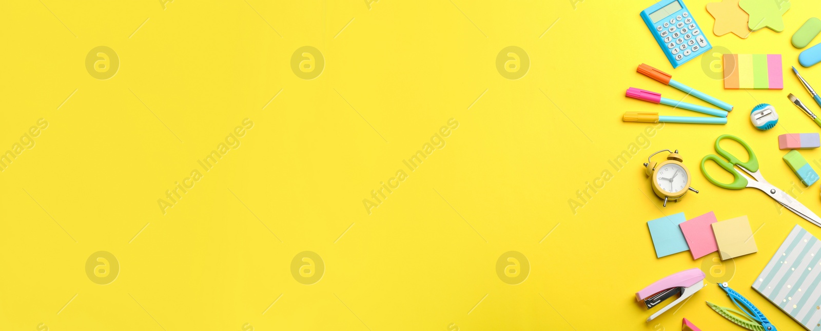 Photo of School stationery on yellow background, flat lay with space for text. Back to school