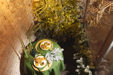Beautiful festive table setting and Christmas decor in room