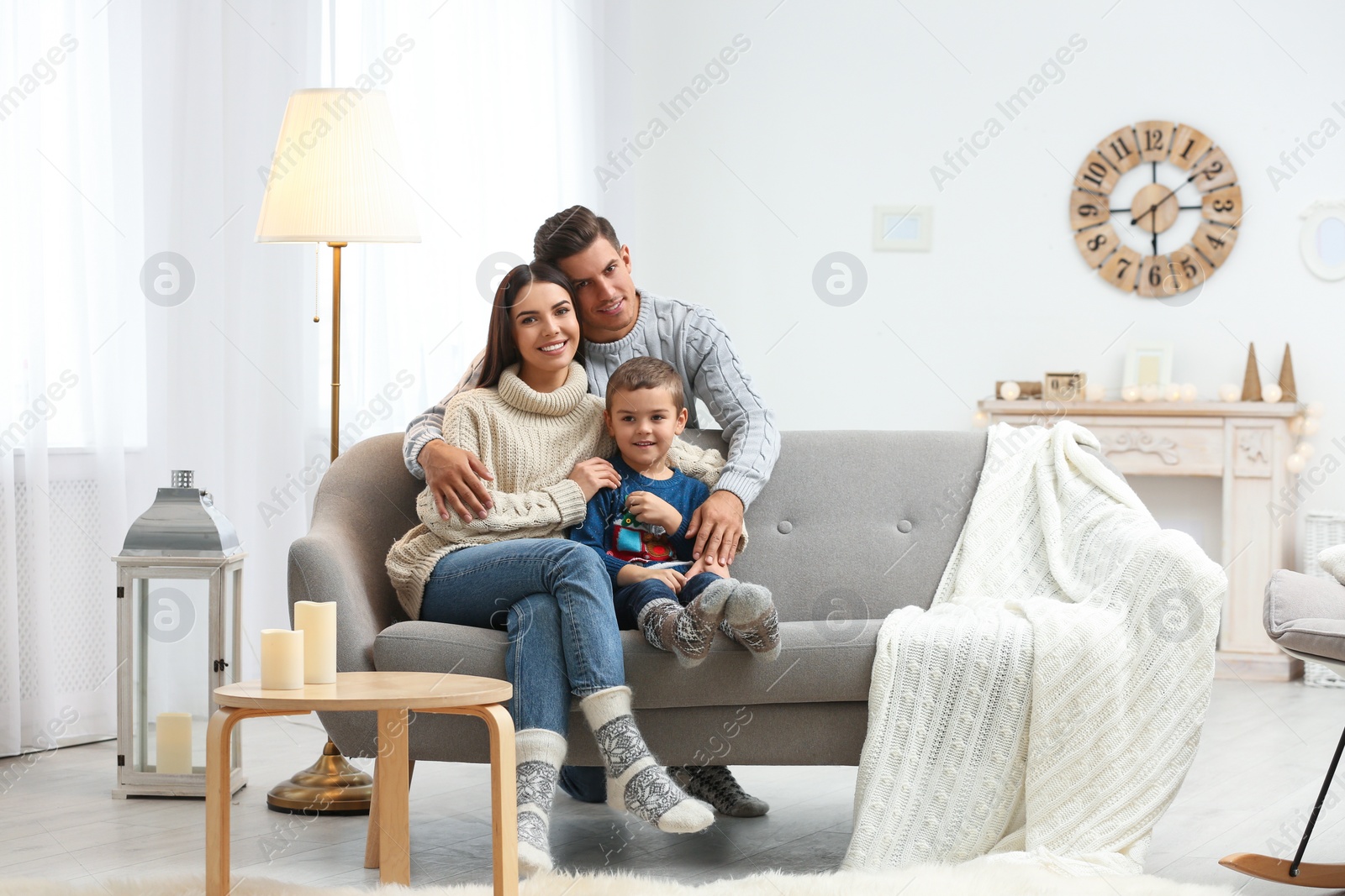 Photo of Happy family with little son spending time together at home. Winter vacation