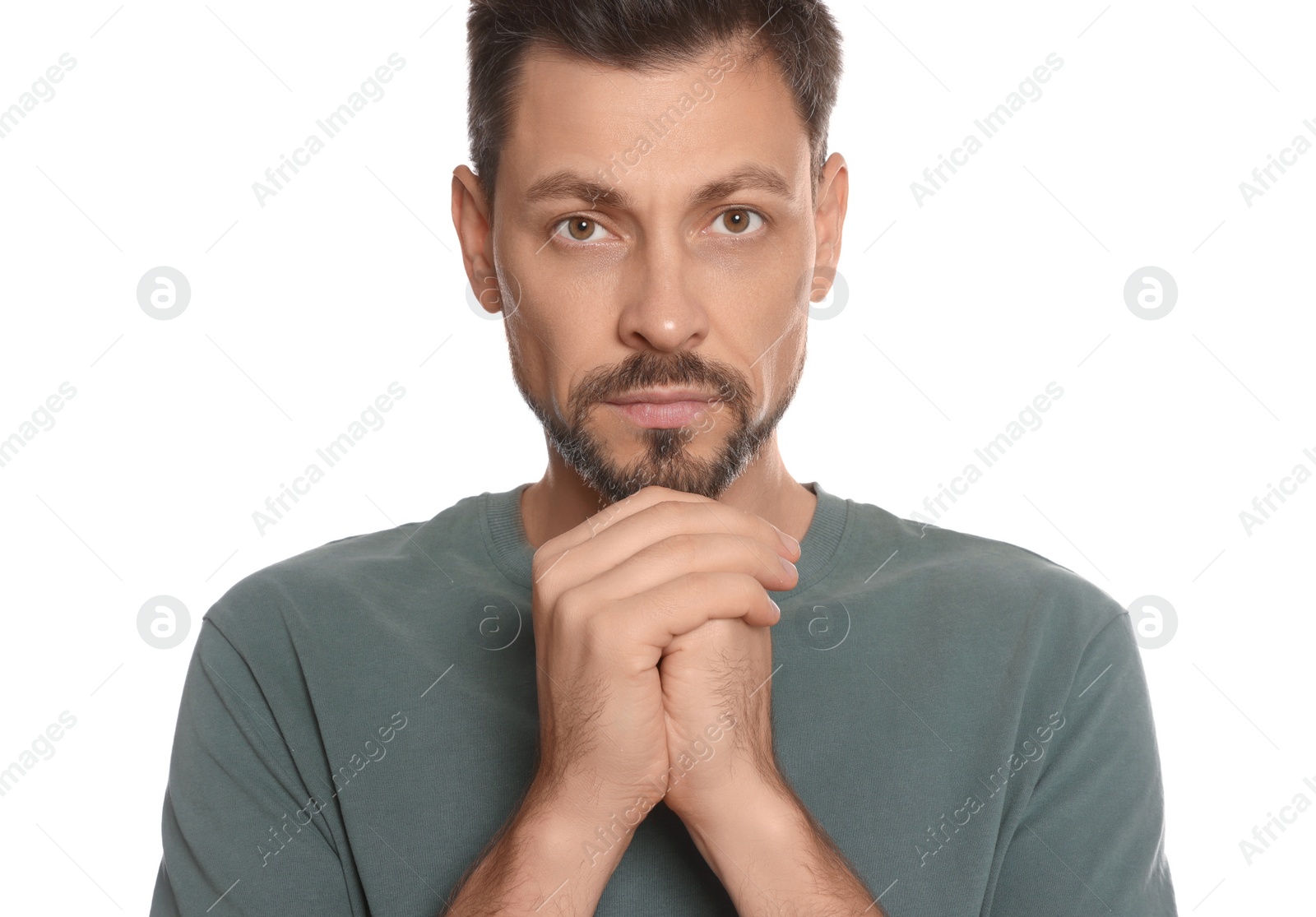 Photo of Man with clasped hands praying on white background