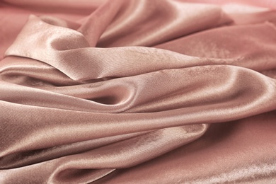 Texture of rose gold silk as background, closeup