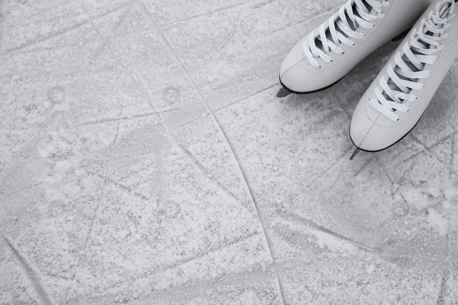 Photo of Figure skates on ice, above view with space for text. Winter outdoors activities