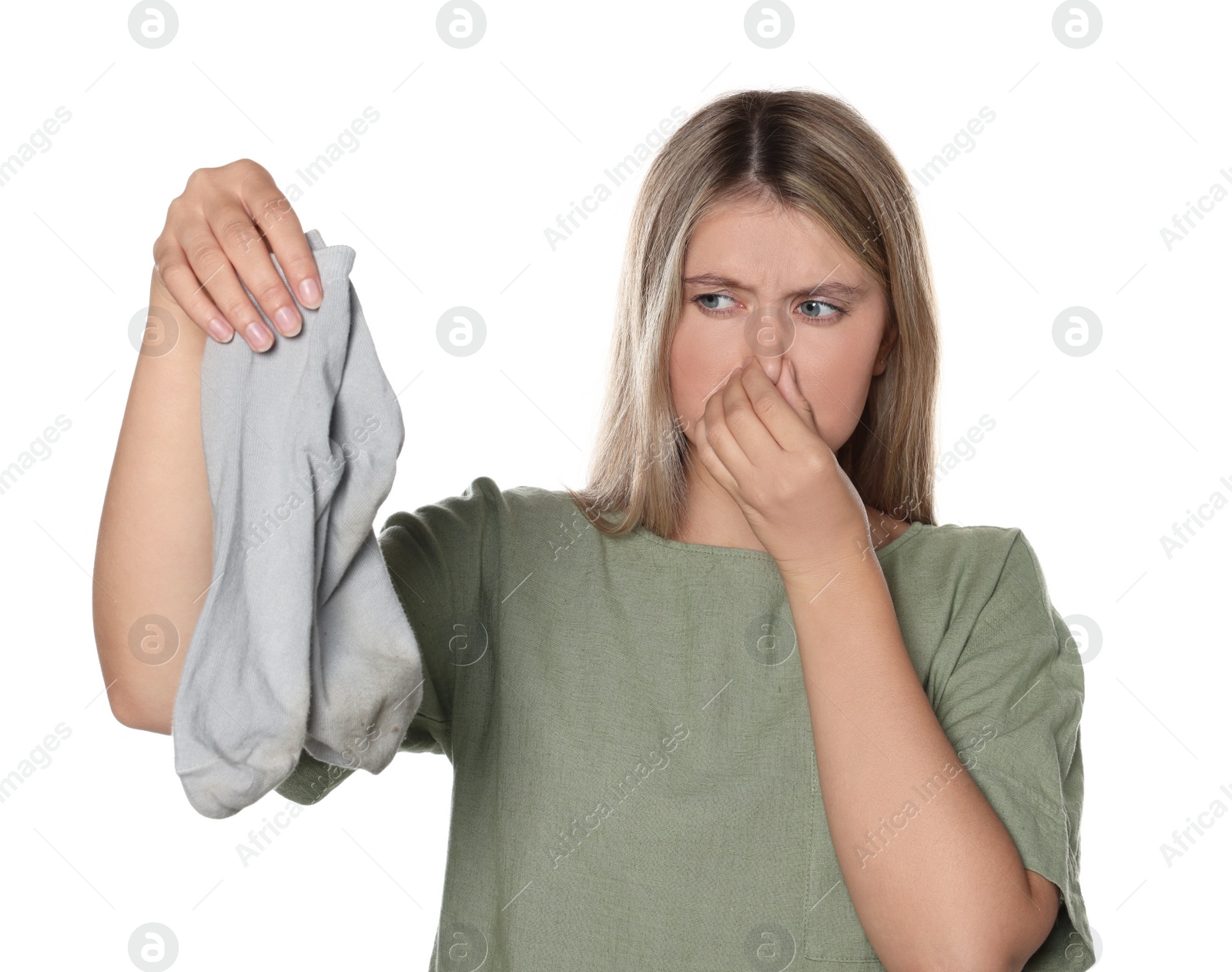 Photo of Young woman feeling bad smell from dirty socks isolated on white