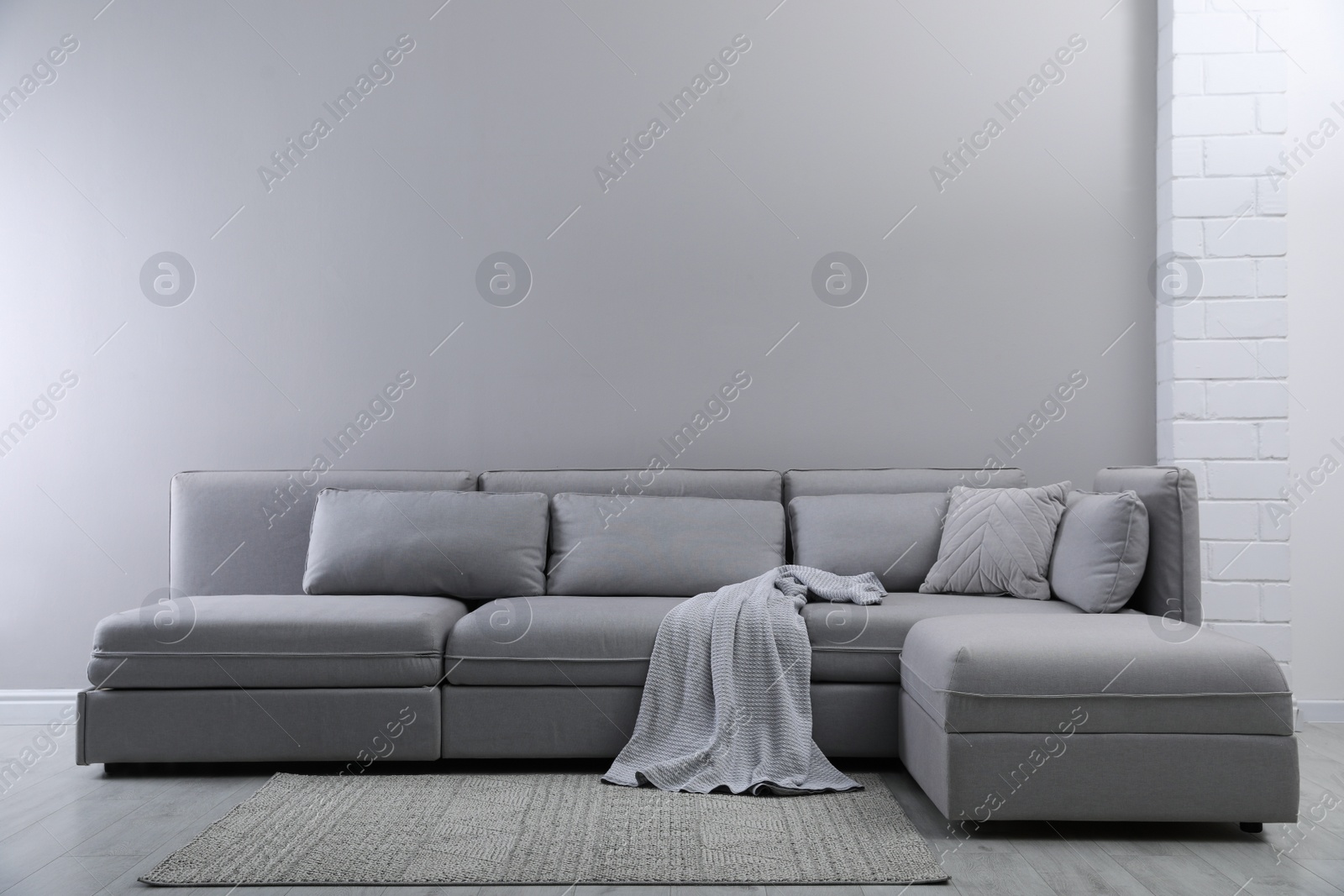 Photo of Large grey sofa in living room. Interior design