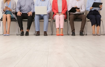 Photo of Group of young people waiting for job interview on chairs