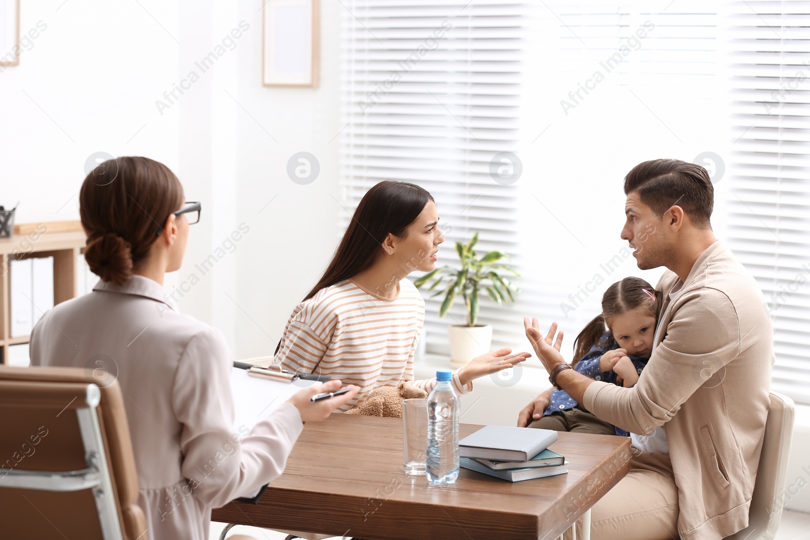 Photo of Professional psychologist working with family in office