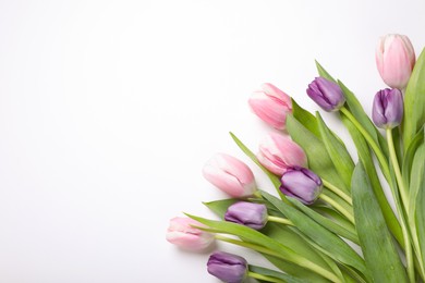 Photo of Beautiful tulips on light background, flat lay. Space for text