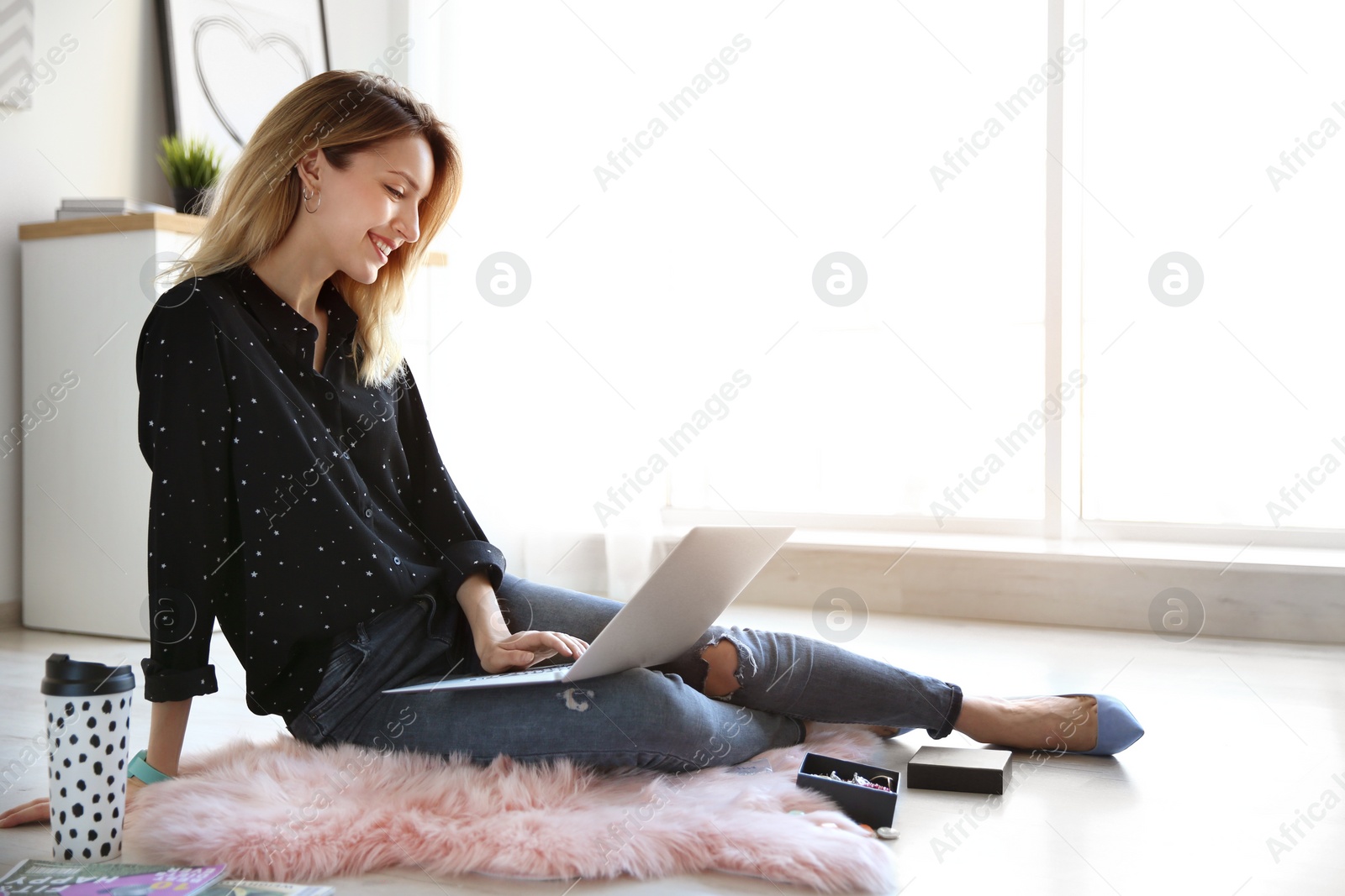 Photo of Young blogger with laptop on floor at home