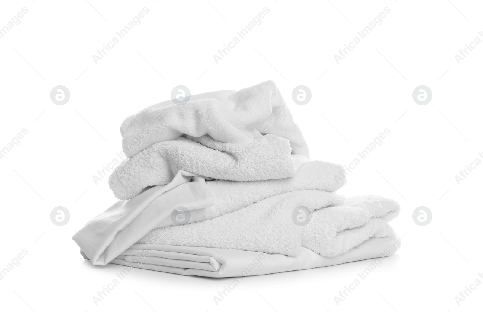 Photo of Pile of towels and bedding on white background