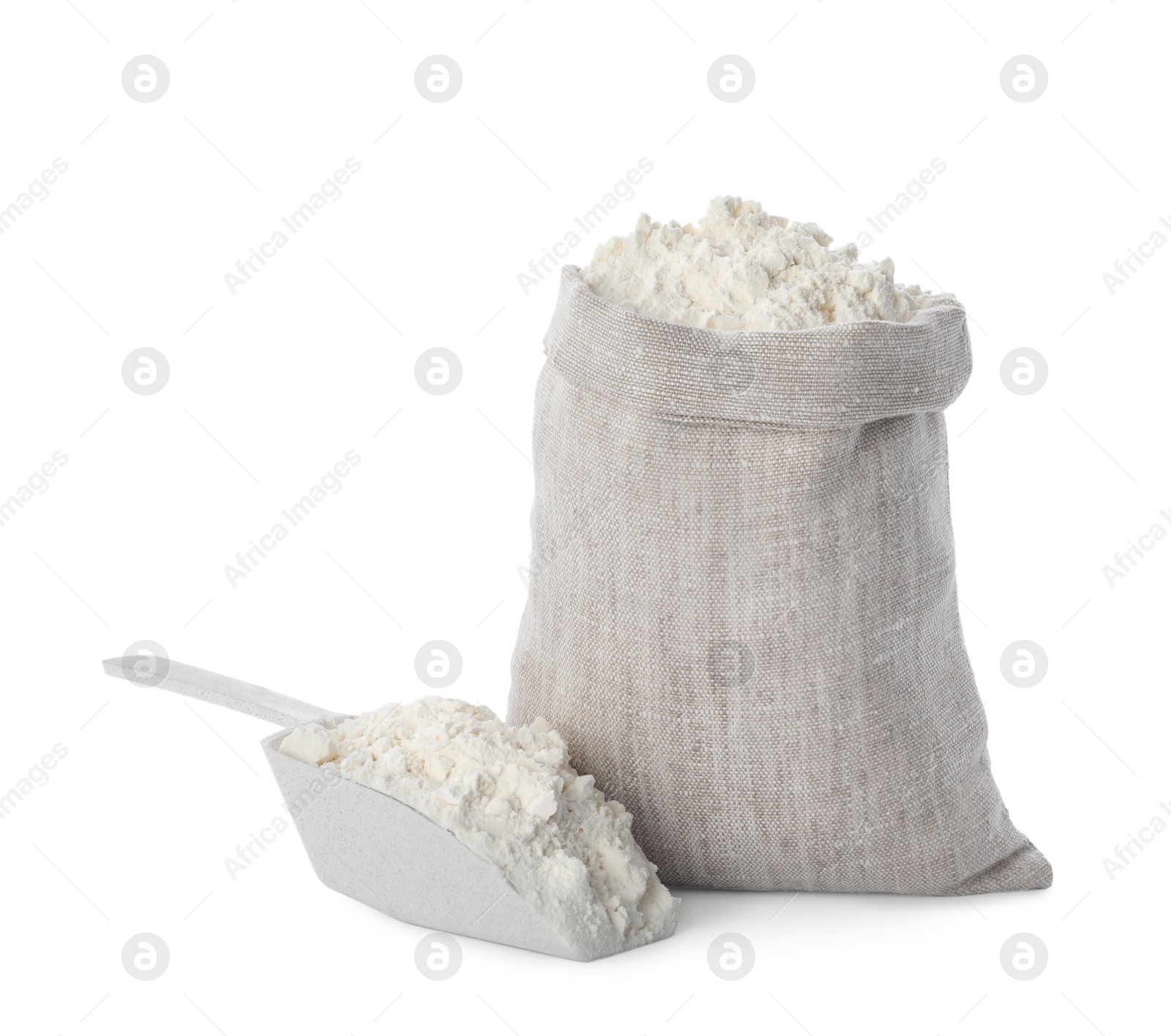 Photo of Sack and scoop with flour on white background