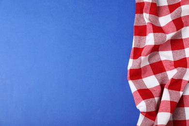 Photo of Checkered picnic blanket on color background, top view. Space for text