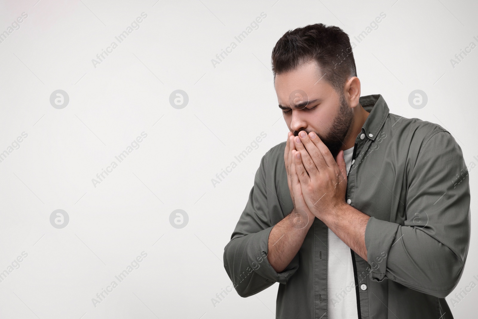 Photo of Sick man coughing on white background, space for text