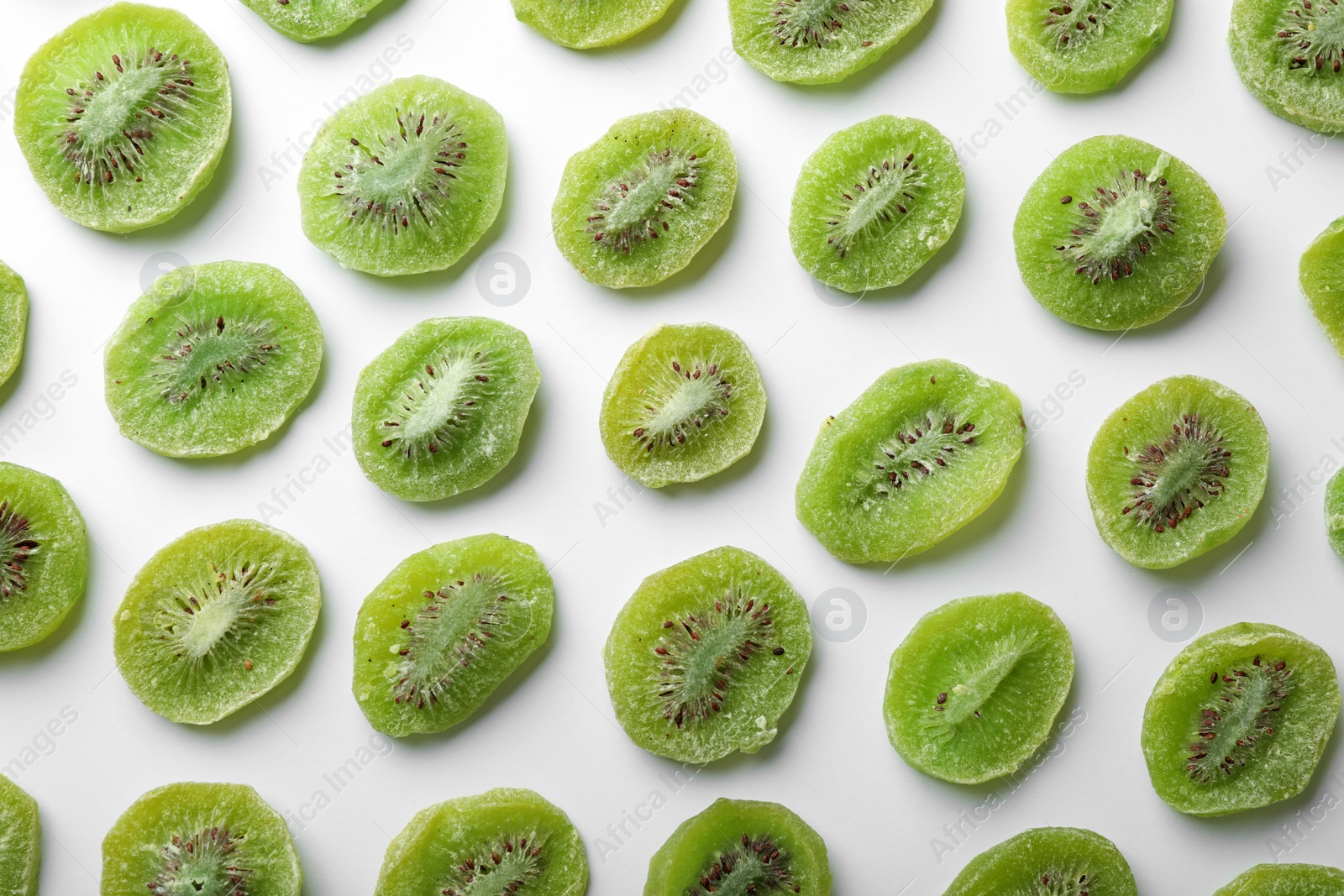 Photo of Slices of kiwi on white background, flat lay. Dried fruit as healthy food