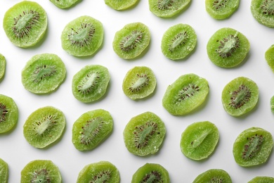 Photo of Slices of kiwi on white background, flat lay. Dried fruit as healthy food