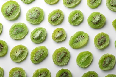 Slices of kiwi on white background, flat lay. Dried fruit as healthy food