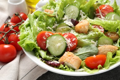 Photo of Delicious salad with chicken, cheese and vegetables on table, closeup