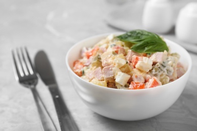 Photo of Delicious salad Olivier on light table, closeup