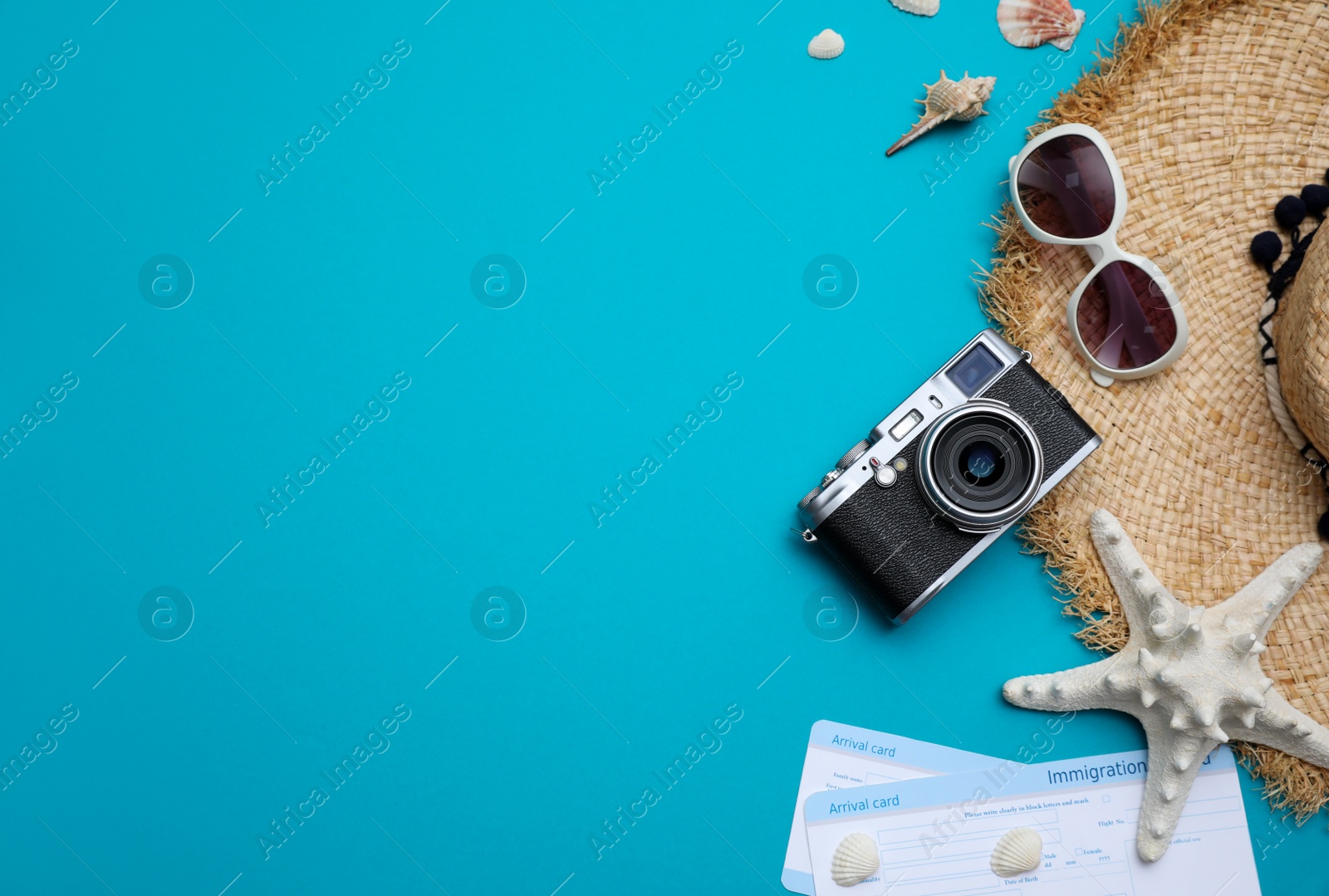 Photo of Travel accessories on light blue background, flat lay. Space for text