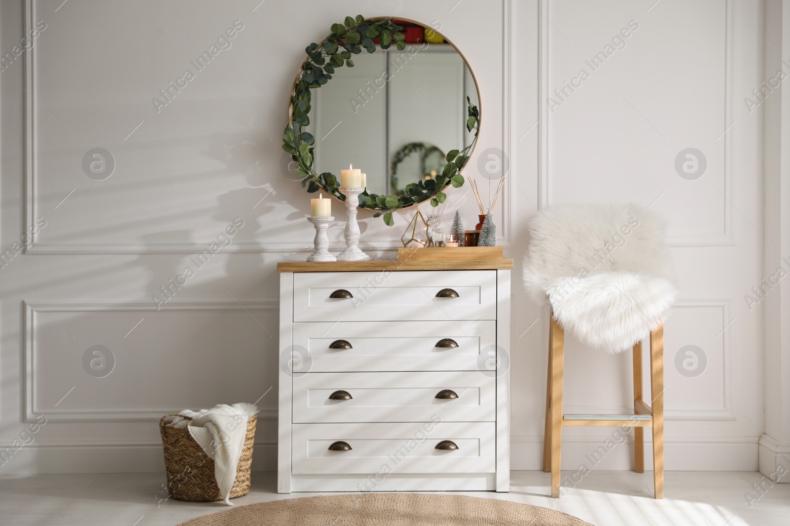 Photo of Modern room interior with chest of drawers and mirror on white wall