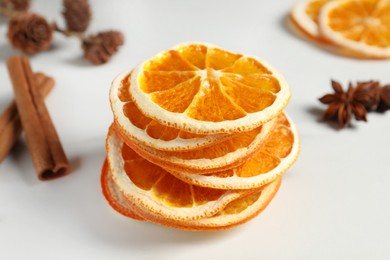 Photo of Dry orange slices on white table, closeup