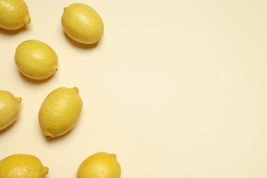 Photo of Fresh ripe lemons on beige background, flat lay with space for text