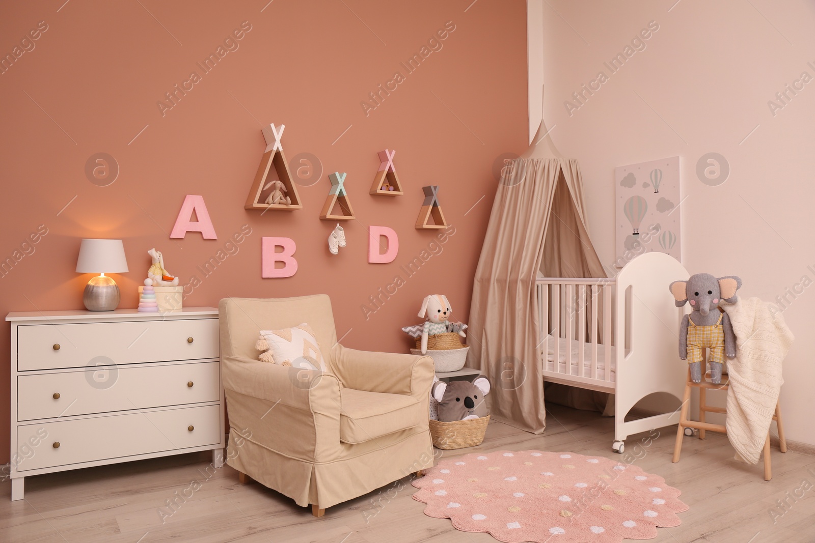 Photo of Baby room interior with stylish furniture and comfortable crib