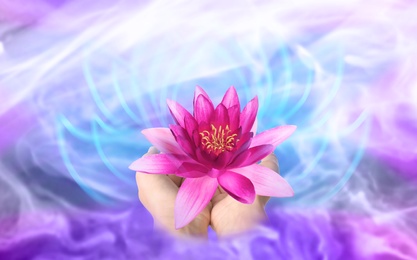 Image of Woman holding beautiful lotus flower on bright background, closeup