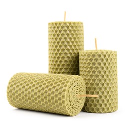 Set of beeswax candles on white background