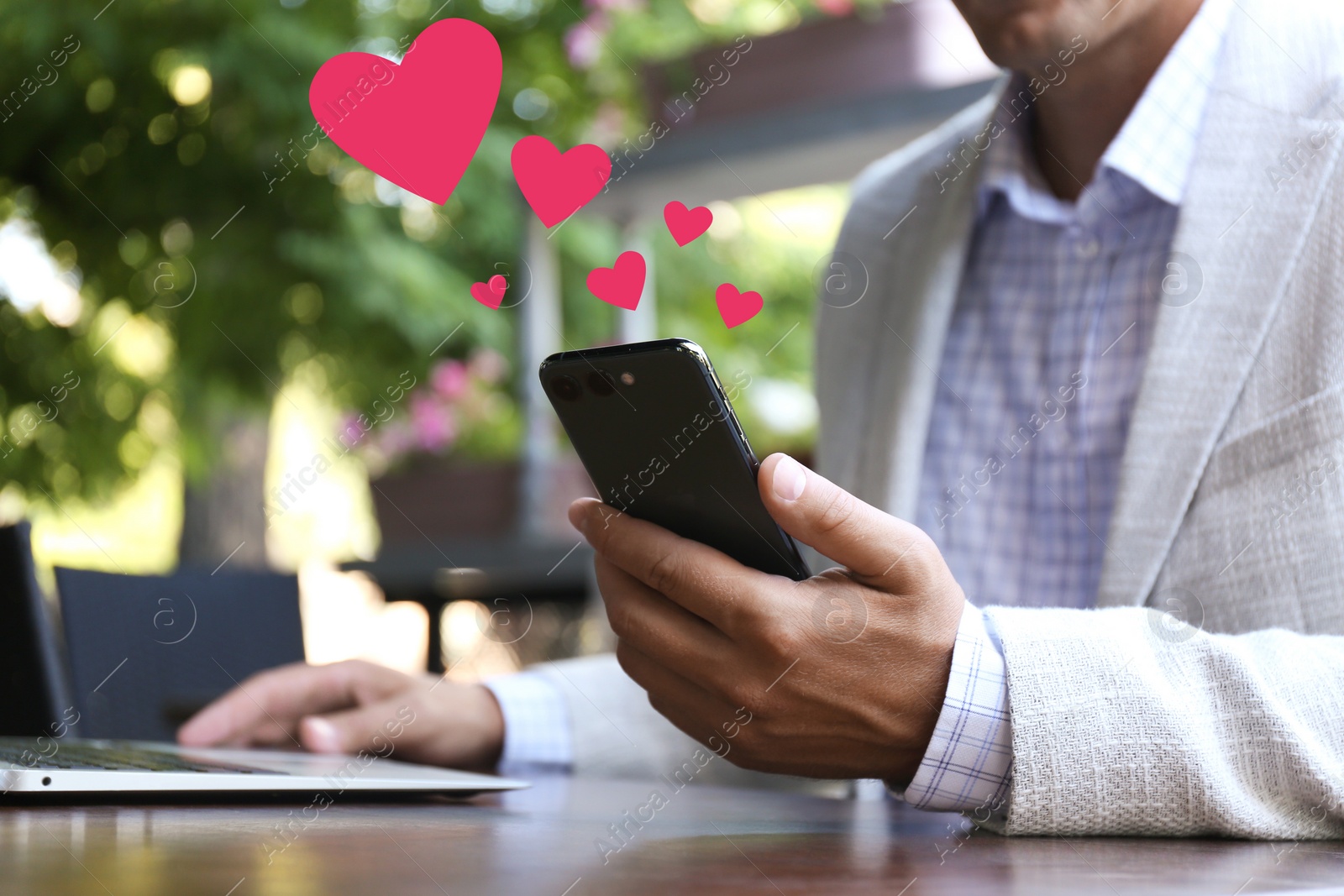Image of Man visiting dating site via smartphone in outdoor cafe, closeup