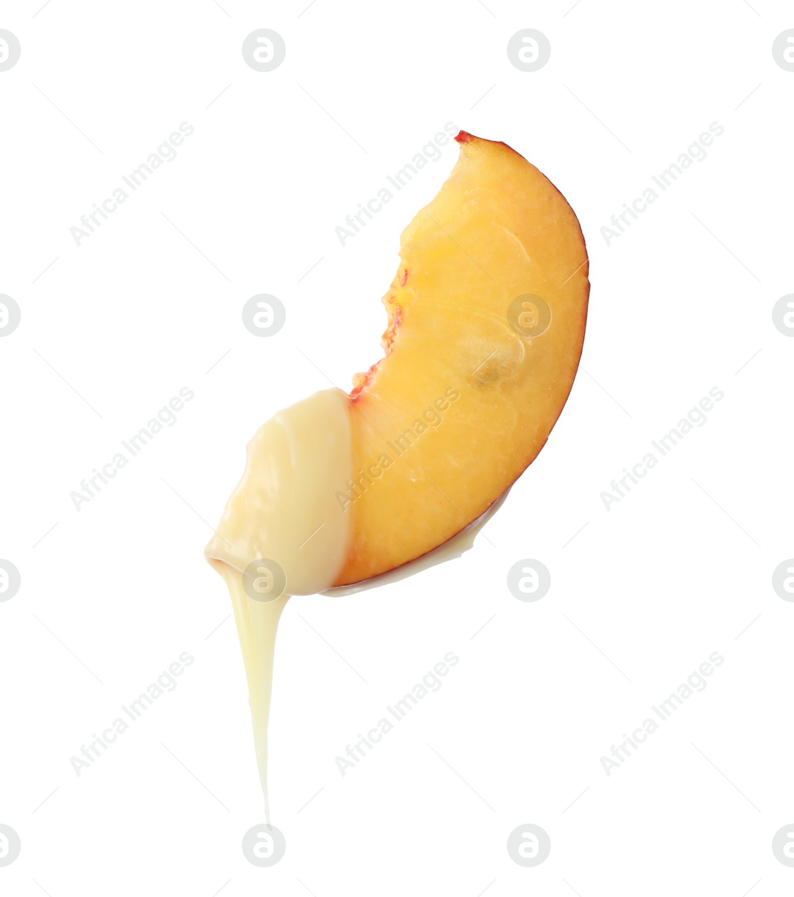 Photo of Fondue fork with slice of peach dipped into chocolate on white background