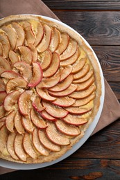 Photo of Freshly baked delicious apple pie on wooden table, top view