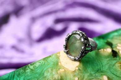 Photo of Beautiful silver ring with prehnite gemstone on textured surface. Space for text