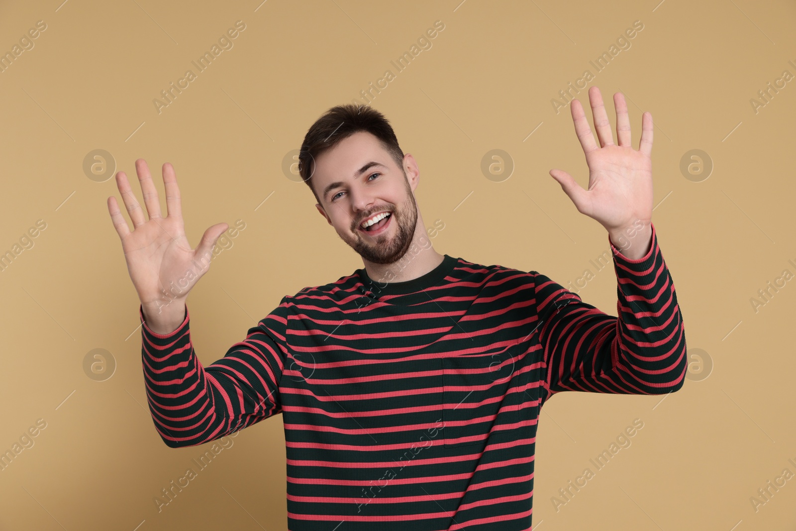 Photo of Man giving high five on beige background