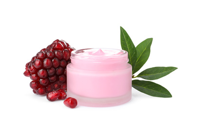 Glass jar with natural facial mask, pomegranate seeds and green leaves isolated on white