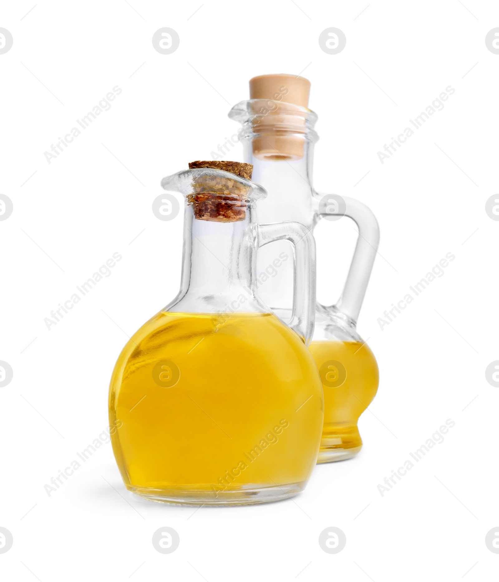 Photo of Glass jugs of cooking oil on white background