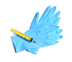 Photo of Medical gloves and empty syringe on white background, top view