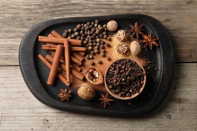 Different spices on wooden table, top view